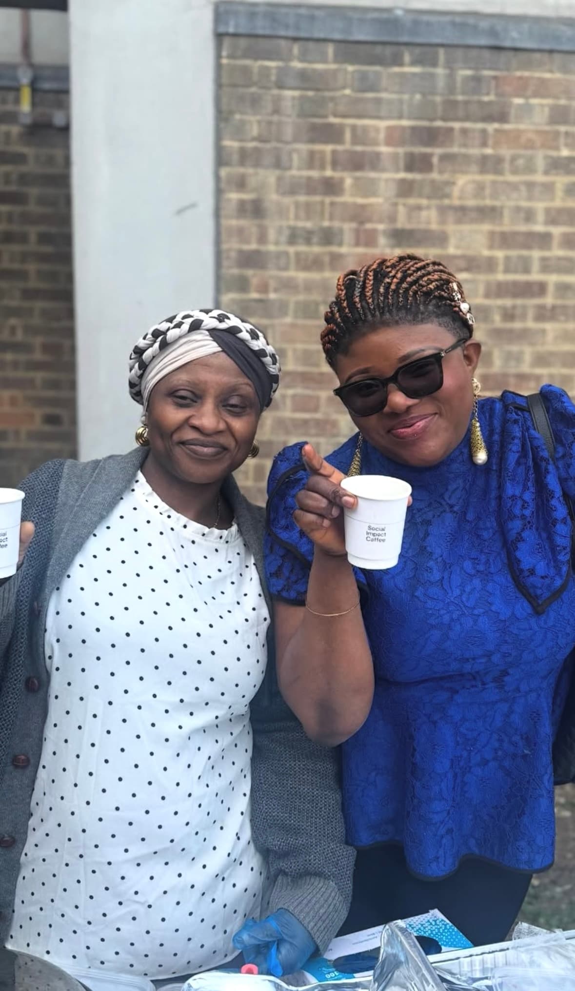 Women and community members with Social Impact Coffee at a BrushPast gathering